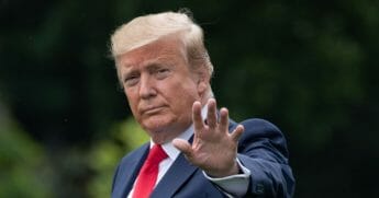 President Donald Trump waves as he walks to Marine One.