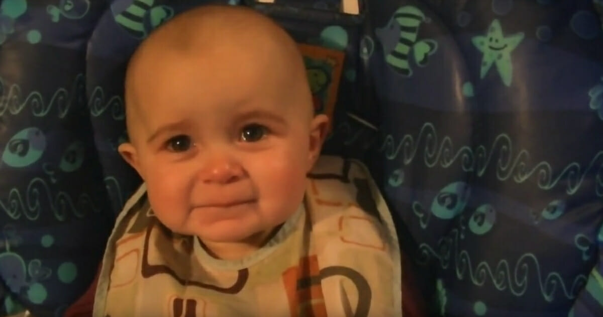 Tears form in a little baby's eyes.