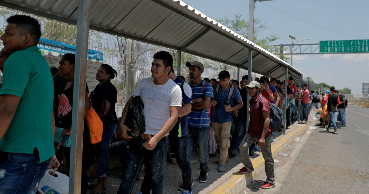 Migrants wait at the international border bridge in Ciudad Tecun Uman, Guatemala.