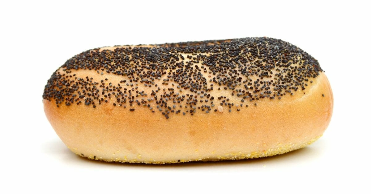 Bagel covered in poppy seeds.
