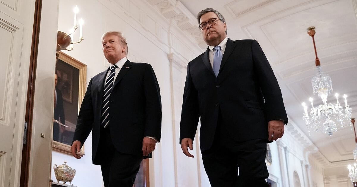 President Donald Trump (L) and Attorney General William Barr walk in the White House.