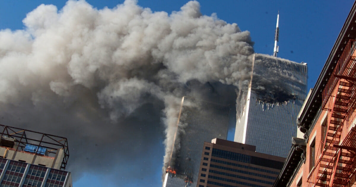 In this Sept. 11, 2001 file photo smoke rises from the burning twin towers of the World Trade Center after hijacked planes crashed into the towers, in New York City.