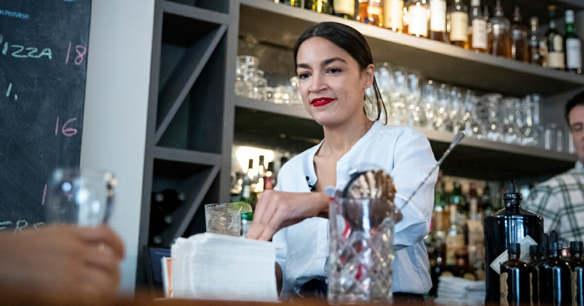 Rep. Alexandria Ocasio-Cortez works behind the bar at the Queensboro Restaurant on May 31, 2019 in the Queens borough of New York City.