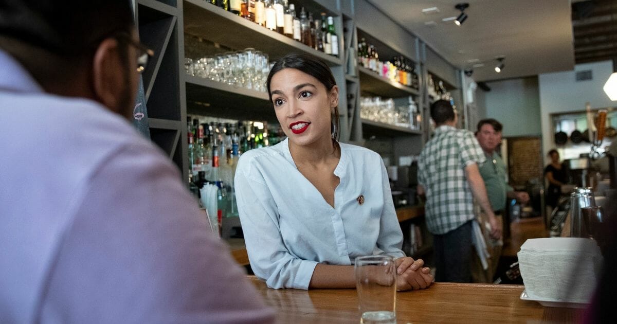 U.S. Rep. Alexandria Ocasio-Cortez (D-NY) works behind the bar at the Queensboro Restaurant, May 31, 2019, in the Queens borough of New York City.