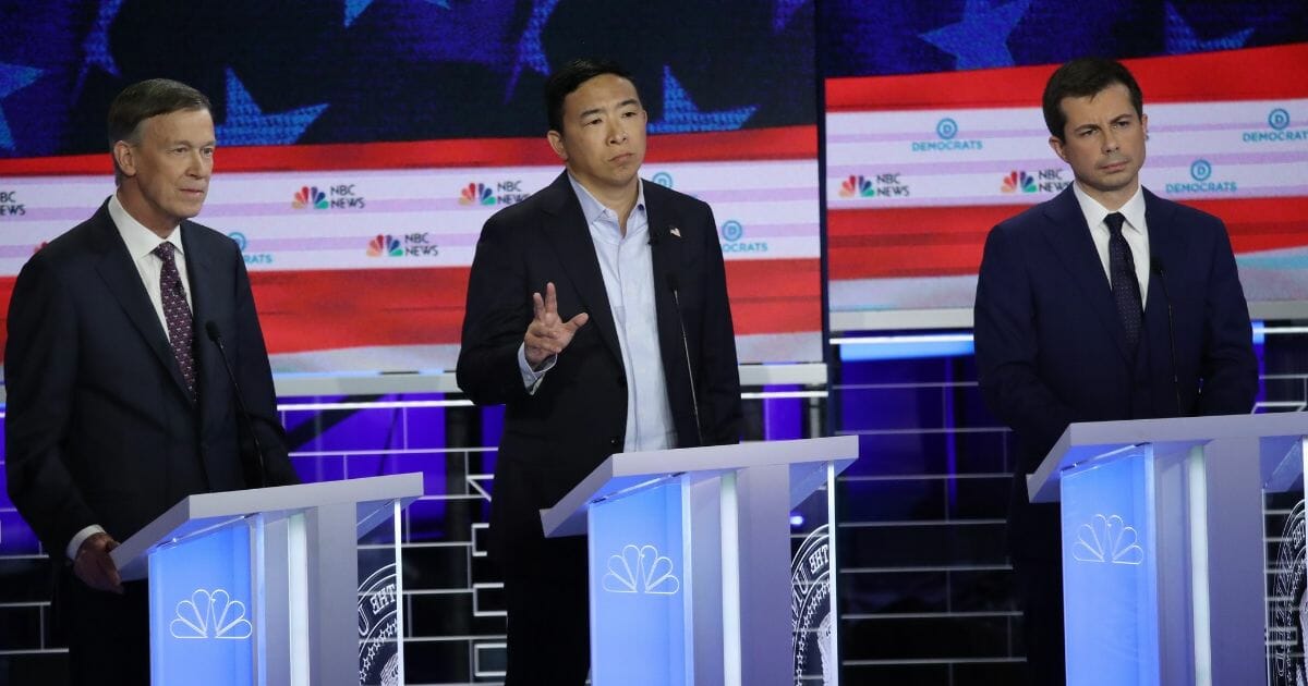 Democratic presidential candidates (Left-Right) former Colorado governor John Hickenlooper, former tech executive Andrew Yang and South Bend, Indiana, Mayor Pete Buttigieg take part in the second night of the first Democratic presidential debate on June 27, 2019, in Miami, Florida.