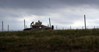 A member of the U.S. Army keeps watch near the U.S.-Mexico International bridge.