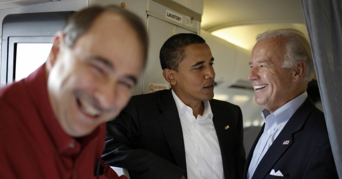 David Axelrod, Barack Obama and Joe Biden aboard a plane on Aug. 28, 2008, in Denver, Colo.