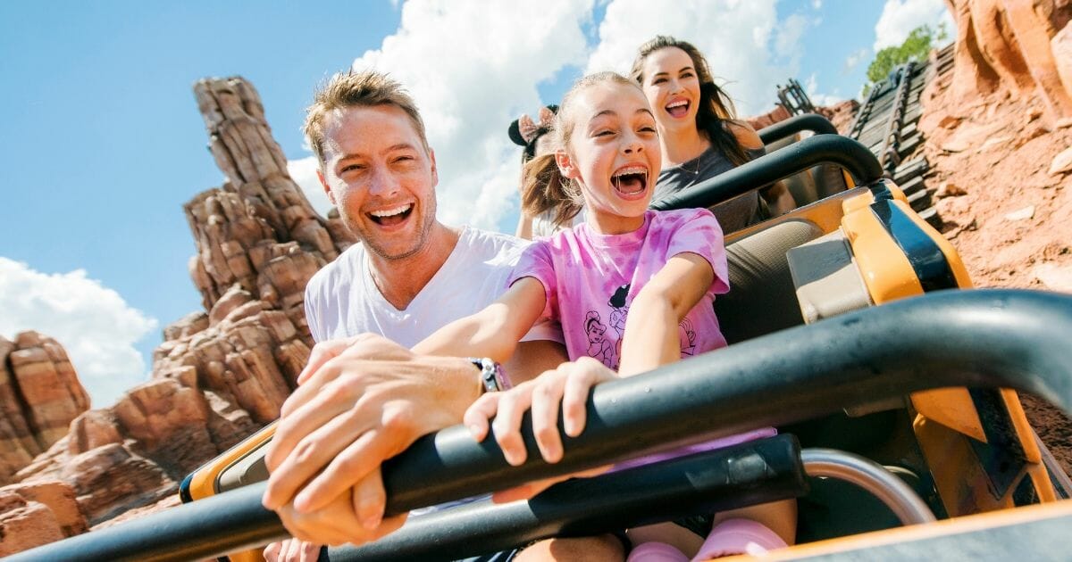 family riding roller coaster