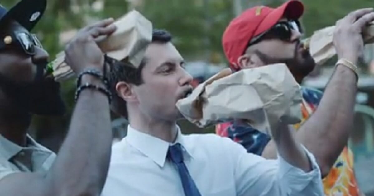 South Bend, Indiana, Mayor Pete Buttigieg drinks from a bottle in a brown paper bag.