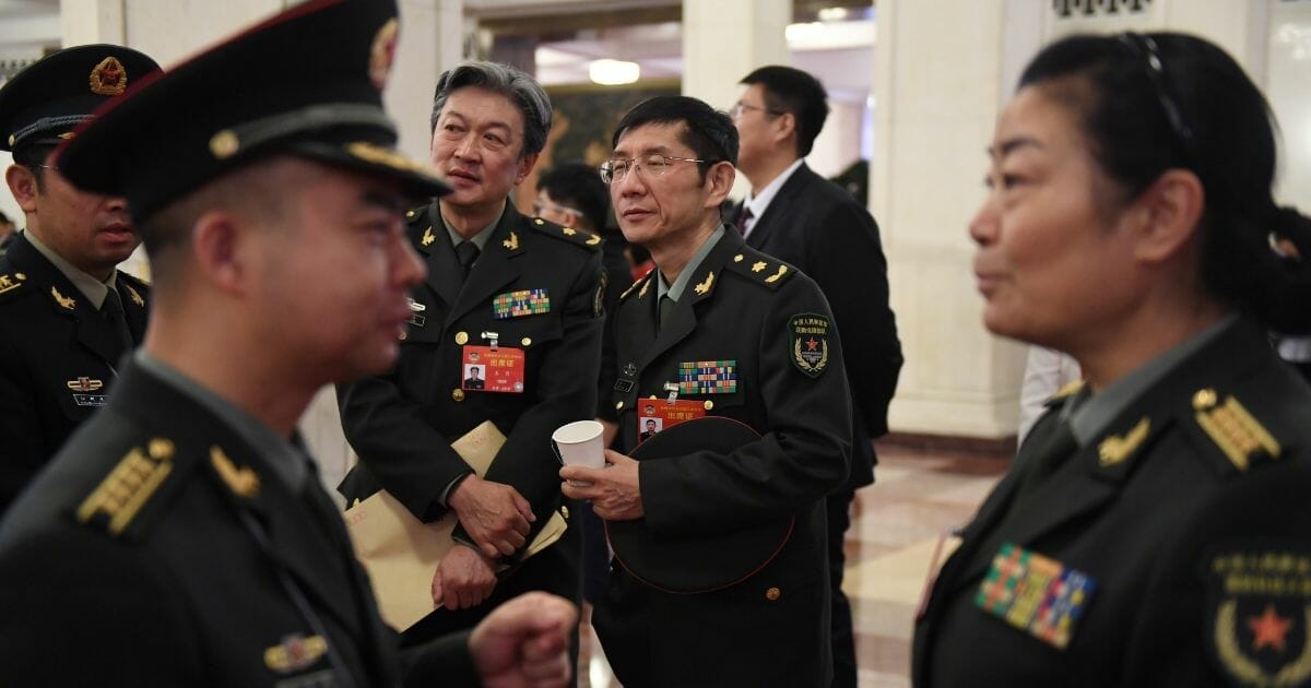 Chinese military delegates chat at the Great Hall of the People in Beijing on March 13, 2019.