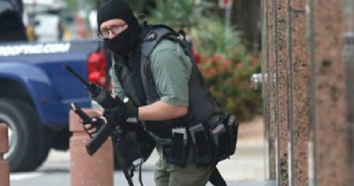 A would-be mass shooter carrying weapons and wearing a tactical vest.