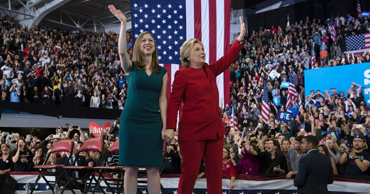 Then-Democrat presidential nominee Hillary Clinton and Chelsea Clinton wave after a midnight rally at Reynolds Coliseum on Nov. 8, 2016 in Morrisville, North Carolina.