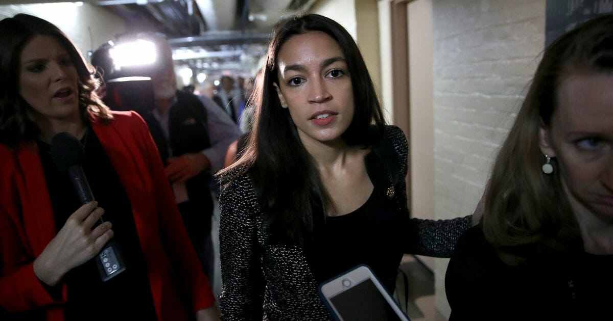 Rep. Alexandria Ocasio-Cortez answers questions from reporters as she leaves a House Democratic caucus meeting on the potential impeachment of U.S. President Donald Trump on May 22, 2019, in Washington, D.C.
