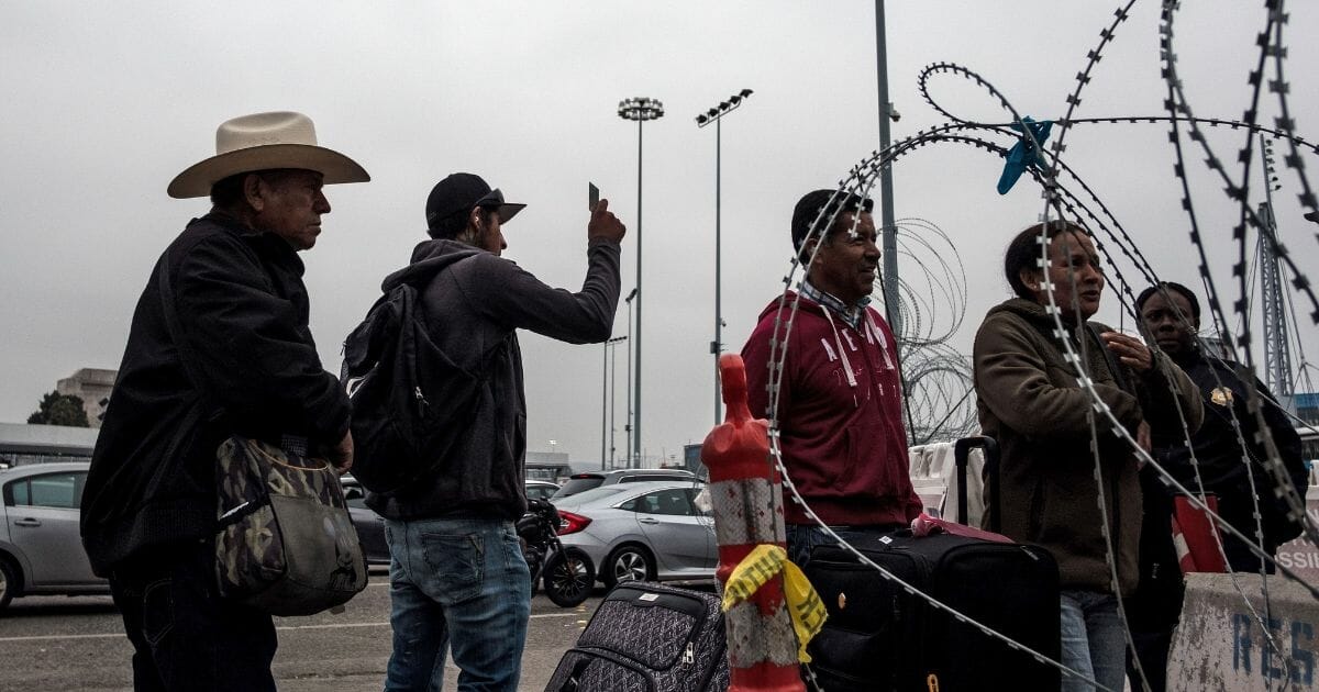 People wait at the San Ysidro border crossing in Tijuana, Baja California State, Mexico, on May 31, 2019.