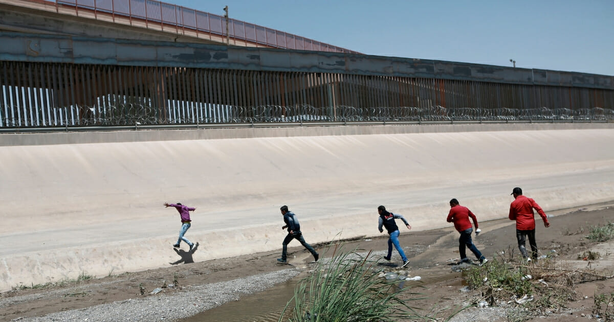 Illegal immigrants cross the Rio Bravo on the U.S.-Mexico border.
