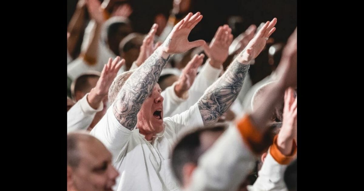 Inmates worshiping during a service.
