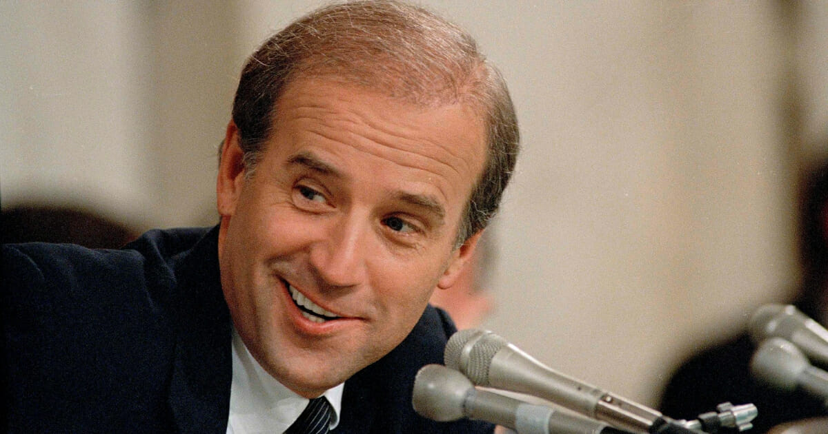 Then-Sen. Joe Biden, D-Del., chairman of the Senate Judiciary Committee, looks to a fellow panel member and laughs during a hearing on the nomination of Judge Robert Bork to become a Supreme Court Justice, on Capitol Hill in Washington, D.C., on Sept. 18, 1987.
