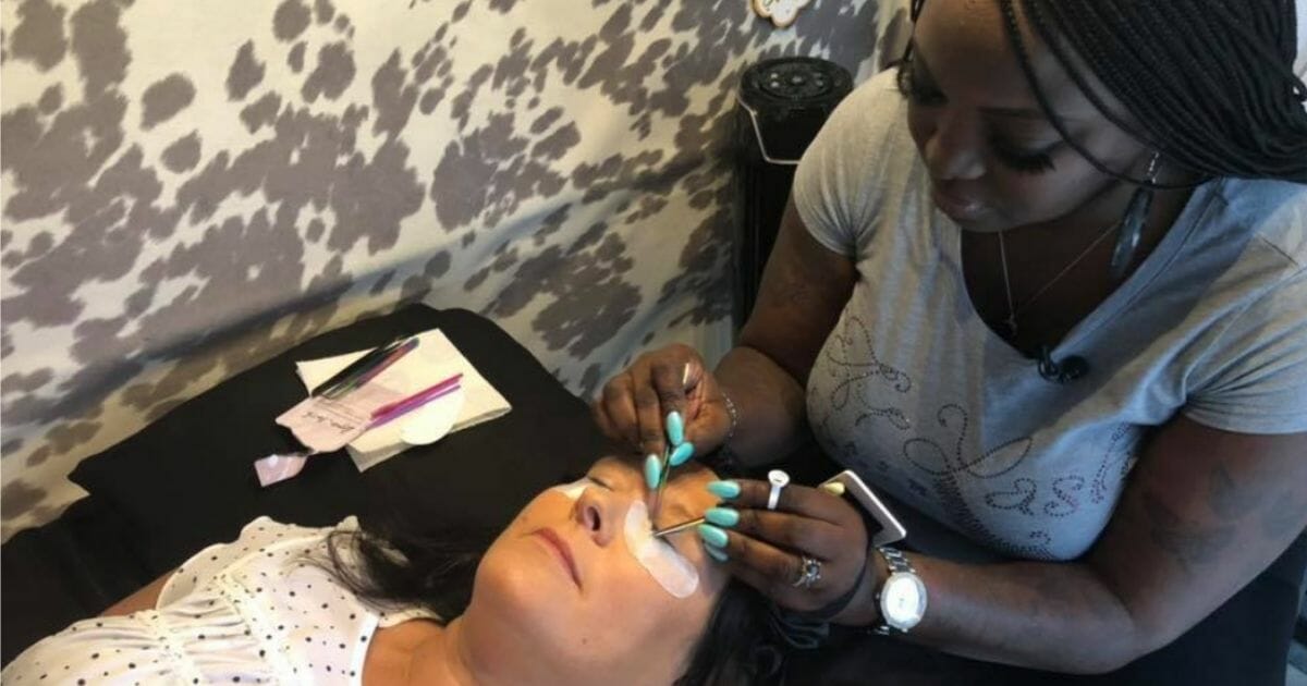 Taylor works with a client in her mobile studio.