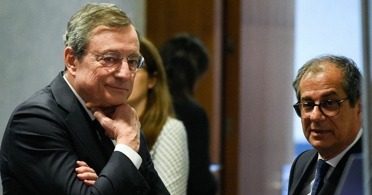 European Central Bank President Mario Draghi, left, observes along with Italy's Economy and Finance Minister Giovanni Tria at the EU headquarters in Luxembourg on June 13, 2019.