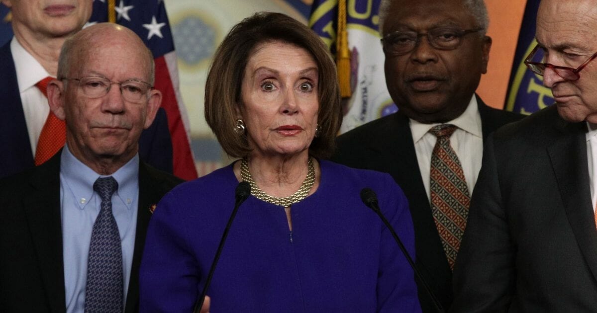 U.S. Speaker of the House Nancy Pelosi speaks to members of the media as Senate Minority Leader Chuck Schumer and other congressional leaders listen after she returned to the Capitol from a White House meeting with President Donald Trump.