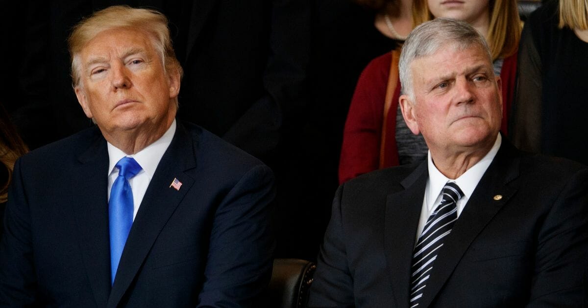 President Donald Trump and Franklin Graham listen during a ceremony honoring the Rev. Billy Graham on Feb. 28, 2018, in Washington, D.C.