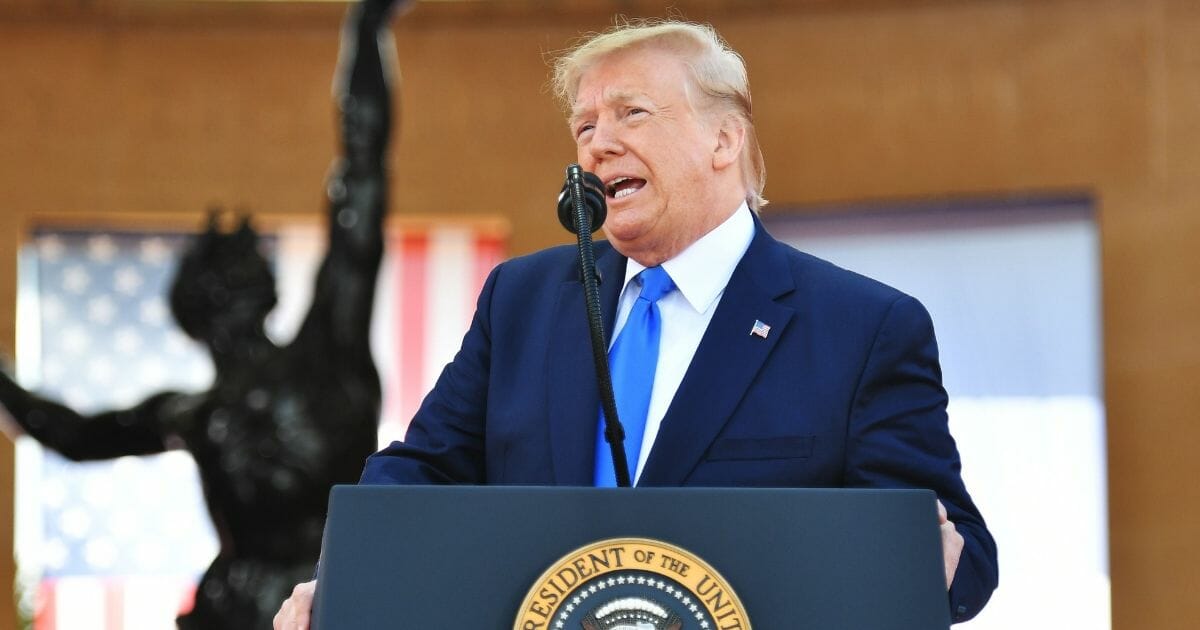 President Donald Trump delivers a speech during a ceremony at the Normandy American Cemetery and Memorial in Colleville-sur-Mer, northwestern France, on Thursday, June 6, 2019.