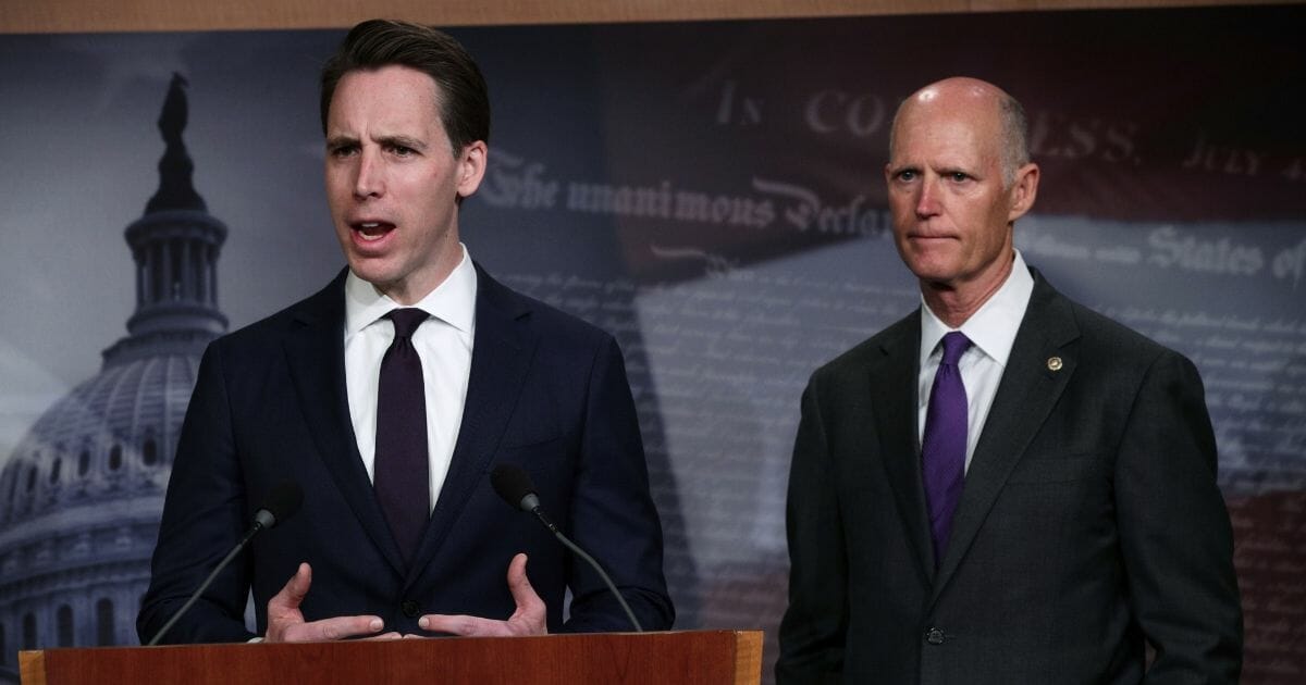 U.S. Sen. Josh Hawley of Missouri, left, speaks as Sen. Rick Scott of Florida, right, listens during a news conference at the U.S. Capitol April 2, 2019, in Washington.