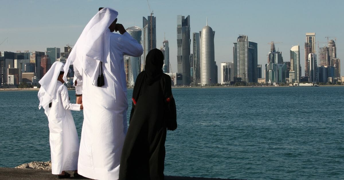 Qataris in tradition Arab clothing view the skyling of Doha, Qatar, in a 2010 file photo.