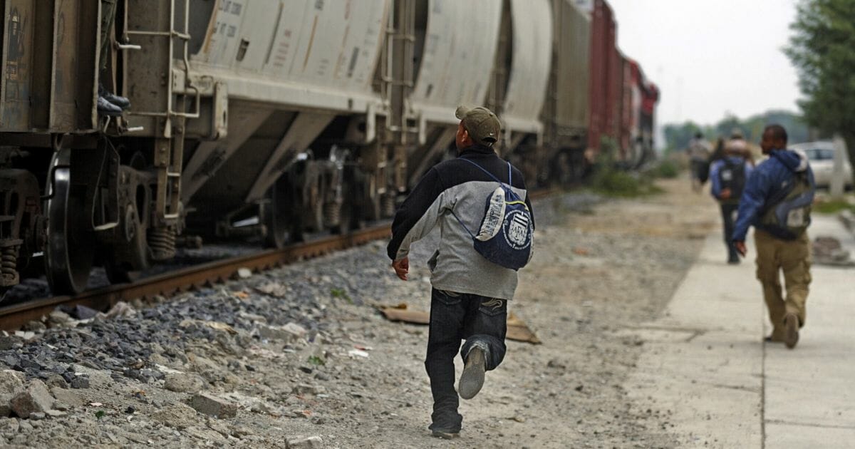 Immigrants hopping train to U.S. border.
