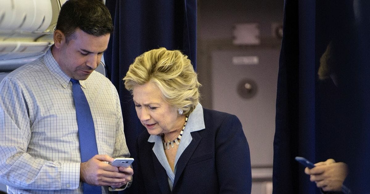 Hillary Clinton campaign spokesman Brian Fallon pictured with Clinton in a 2016 file photo.