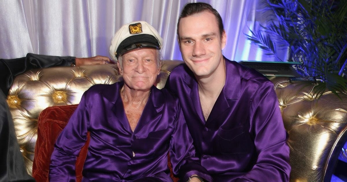 Cooper Hefner with his late father, Playboy founder Hugh Hefner, in a file photo from 2014.