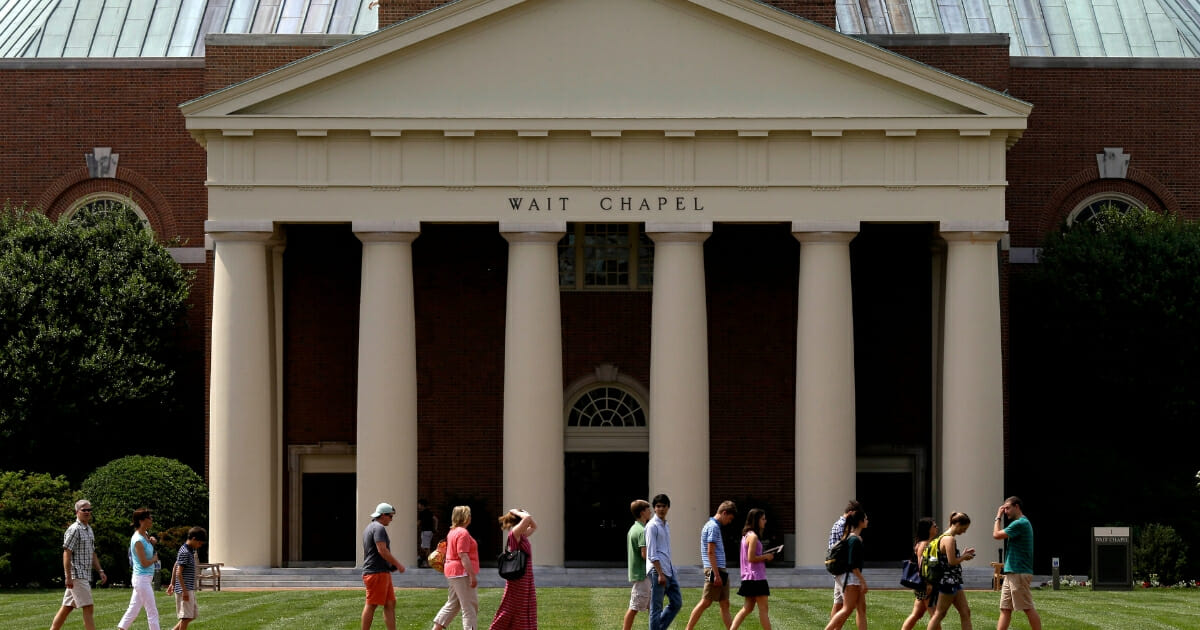 A group walks across the lawn on the campus of Wake Forest University in Winston-Salem, North Carolina on May 28, 2014.