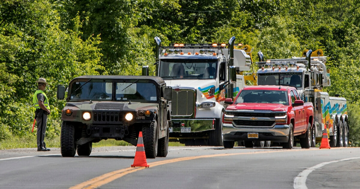 Military police direct traffic along Route 293 near the site where an armored personnel vehicle overturned, killing at least one person on June 6, 2019, in Cornwall, N.Y.