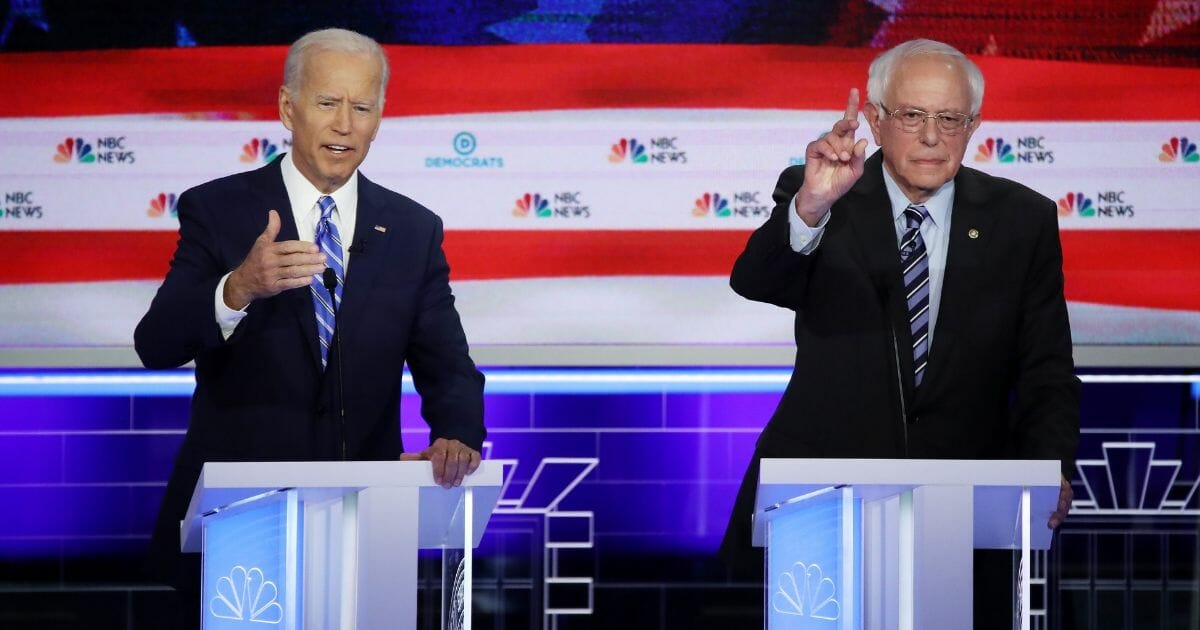 Democratic presidential candidates former Vice President Joe Biden and Sen. Bernie Sanders speak during the second night of the first Democratic presidential debate on June 27, 2019 in Miami, Florida.