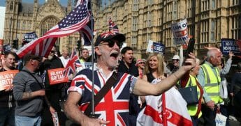 Pro-Brexit demonstrators march past the Houses of Parliament in central London.