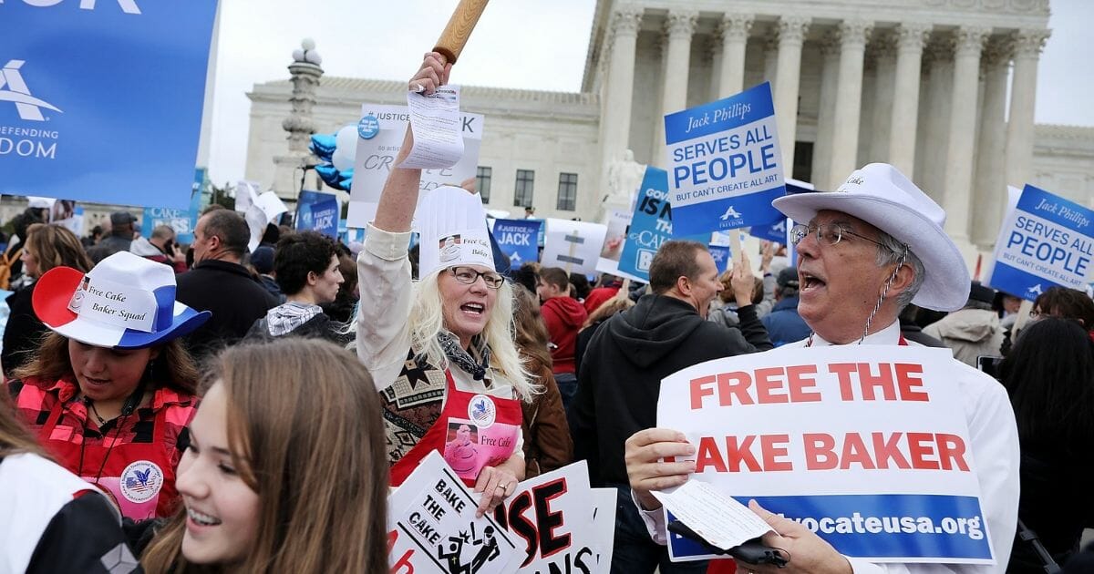 Demonstrators rally in front of the Supreme Court building on the day the court is to hear the case Masterpiece Cakeshop v. Colorado Civil Rights Commission December 5, 2017.