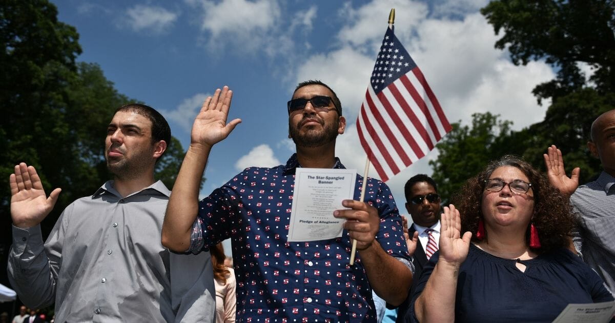 Citizenship candidates take the Oath of Allegiance in a naturalization ceremony at George Washington's Mount Vernon.