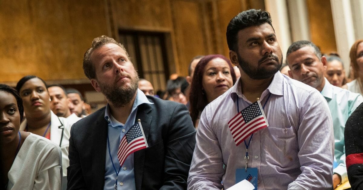 Immigrants participate in a naturalization ceremony to officially become U.S. citizens.