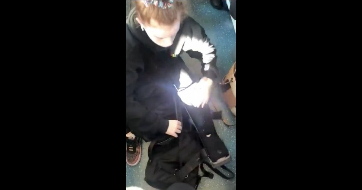 Girl sitting on the floor of a train