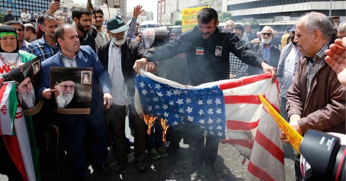 Iranian demonstrators burn a makeshift US flag during a rally in the capital Tehran, on May 10 2019.