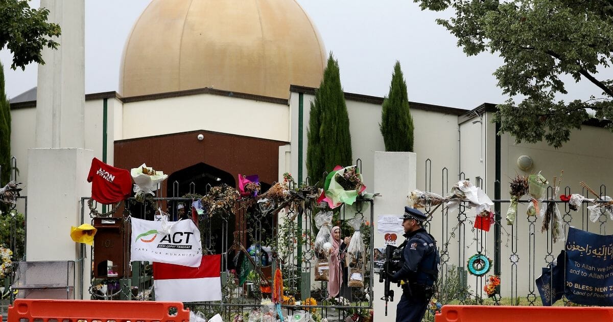 An armed police officer stands guard outside the Al Noor mosque, one of the mosques where some 50 people were killed by a self-avowed white supremacist gunman on March 15, in Christchurch.