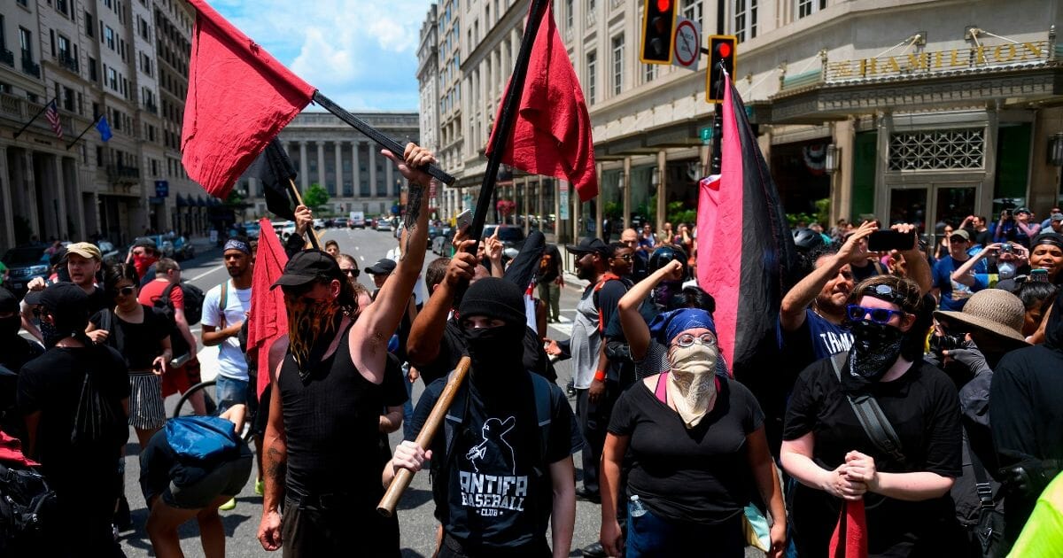Members of an anti-fascist or Antifa group march as the Alt-Right movement gathers for a "Demand Free Speech" rally in Washington, D.C., on July 6, 2019.