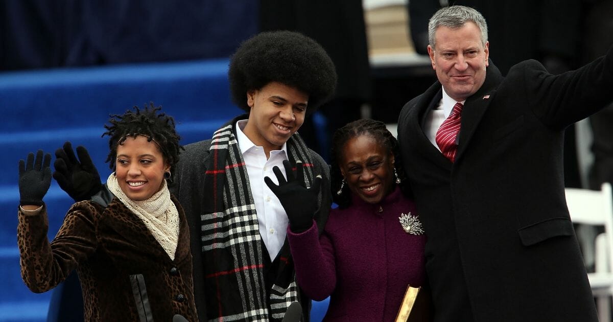 New York City's 109th Mayor Bill de Blasio stands on stage with his family Chiara de Blasio (left) Dante de Blasio (center left) and wife Chirlane McCray (center) at City Hall on Jan. 1, 2014, in New York City.