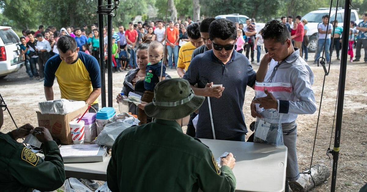 Border Patrol agents interview immigrants on July 2, 2019, in Los Ebanos, Texas.