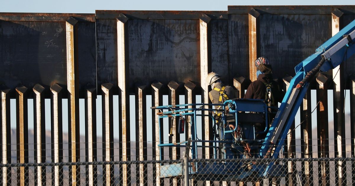People work on the U.S./ Mexican border wall on Feb. 12, 2019, in El Paso, Texas.