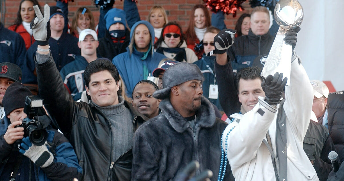 Tedy Bruschi, left, and his New England Patriots teammates ride in a victory parade Feb. 5, 2002, in Boston after beating the St. Louis Rams in Super Bowl XXXVI.