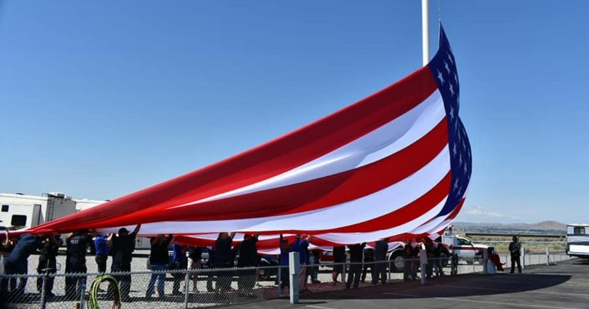giant american flag being raised