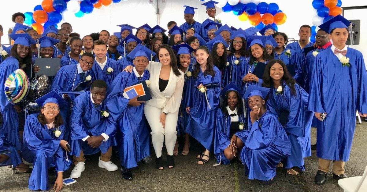 New York's Success Academy Bronx 2 teacher Karina Mateo poses with recent graduates.