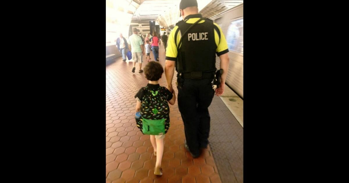 Cop walks boy