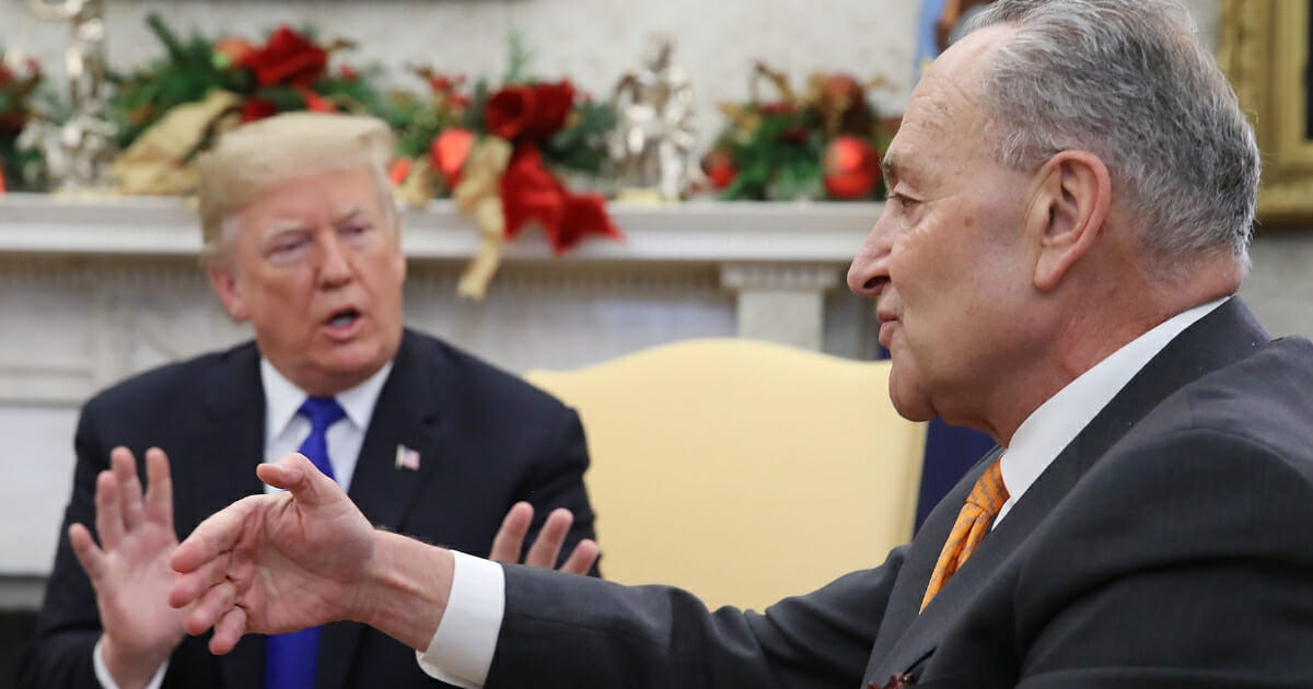 President Donald Trump, left, argues about border security with Senate Minority Leader Chuck Schumer in the Oval Office on Dec. 11, 2018 in Washington, D.C.